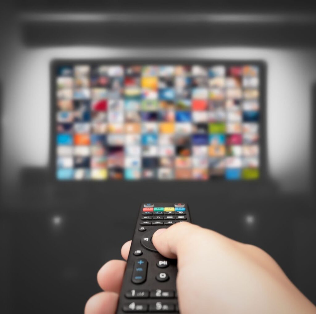 Video on demand, TV streaming, multimedia. Hand holding remote control