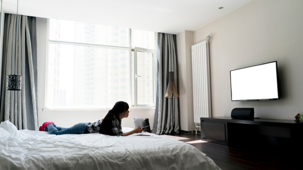 Woman Watching TV In Hotel