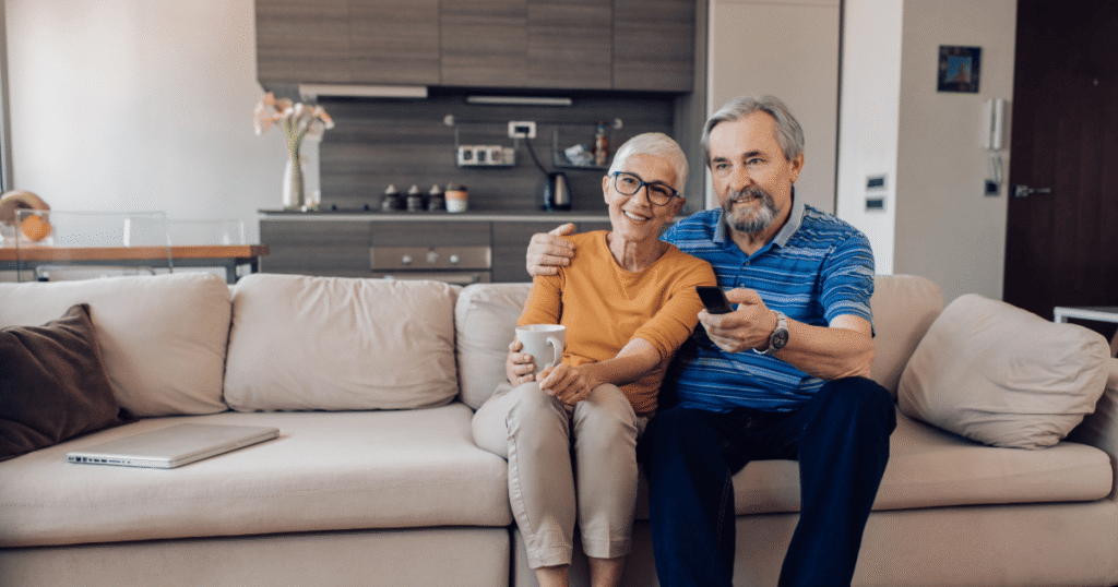 Couple watching TotalVue IPTV entertainment at senior living community