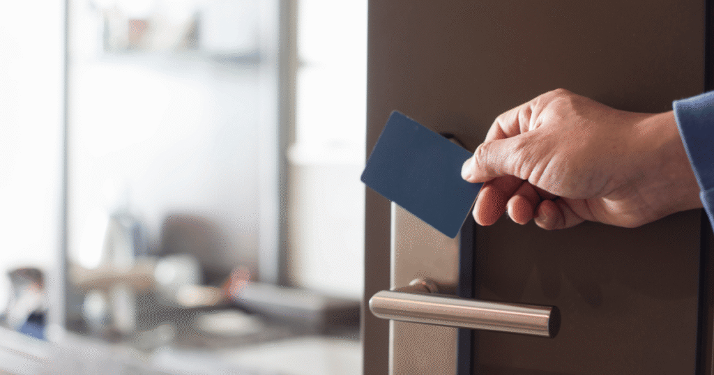 Person using key card to get into commercial space using access control solutions