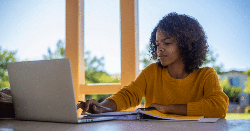 Student using laptop connected to managed wi-fi at her student housing complex