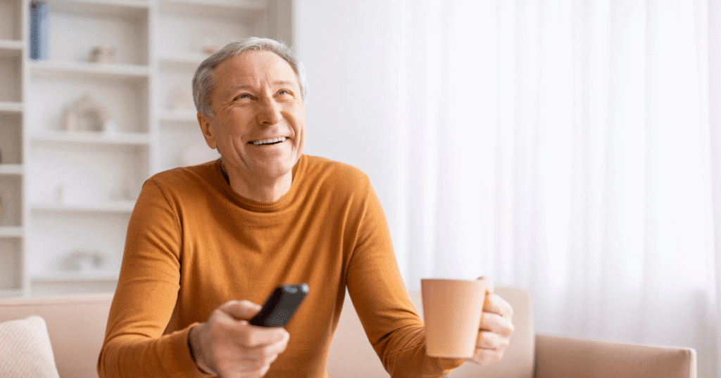 Senior living resident using accessible remote watching DIRECTV (1)