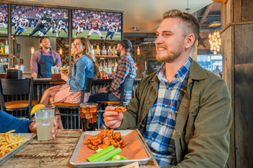 patrons at hotel bar watching sports on DIRECTV