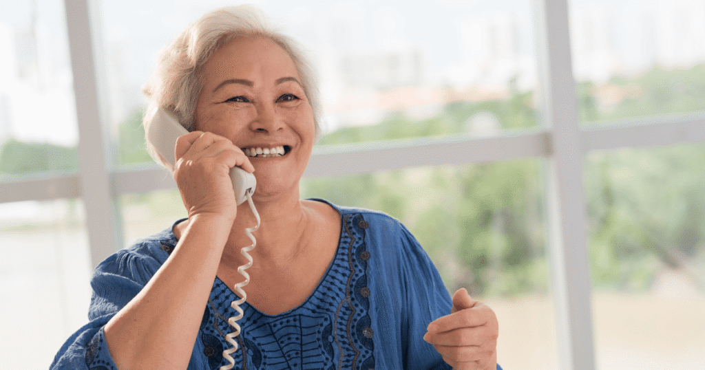woman using VoIP phone at senior living community