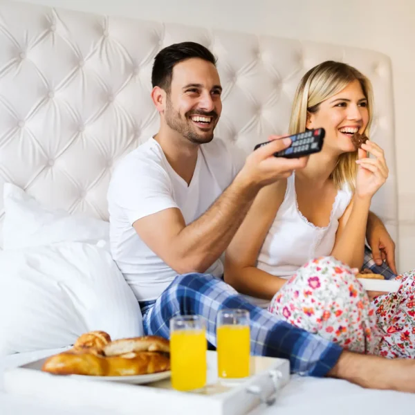 Young couple enjoying TV at Hotel