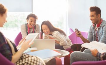University students using technology in lounge