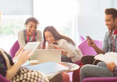 University students using technology in lounge