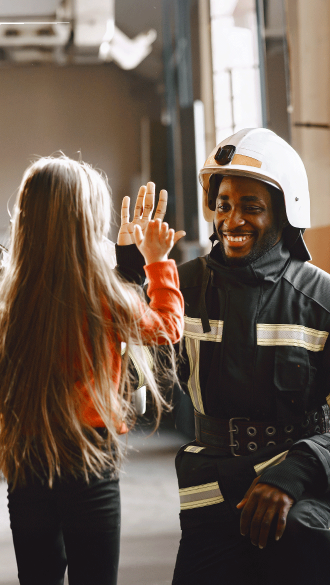 Fireman high-fiving child