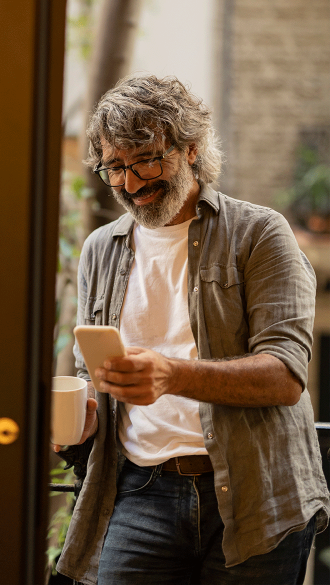 Gentleman Smiling At Connected Cell Phone