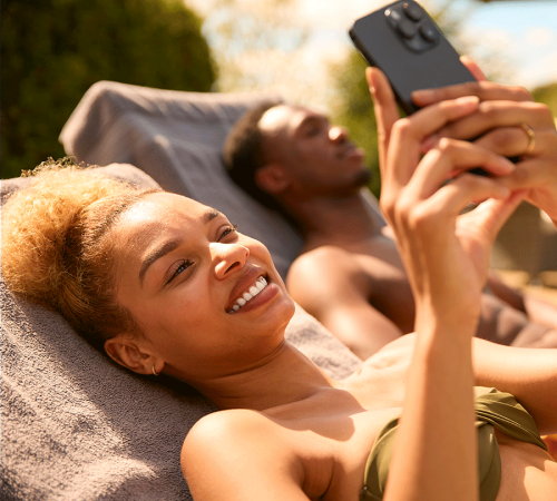 Young Couple Enjoying Cell Phone Service on Vacation