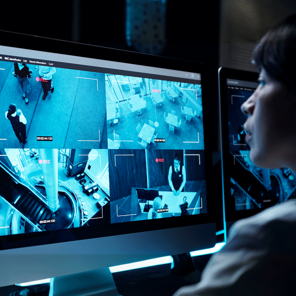 Woman monitoring cameras on screens