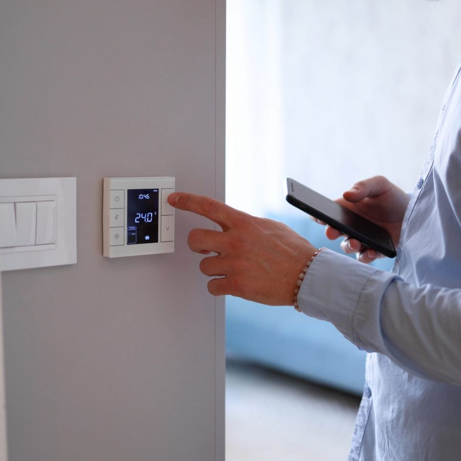 Man using smart home technology at his apartment