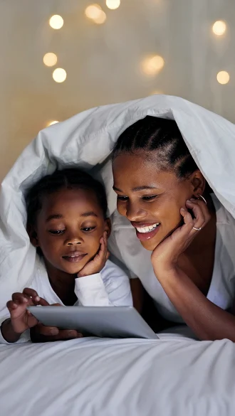 Mother and Daughter Watching Tablet Using Wi-Fi