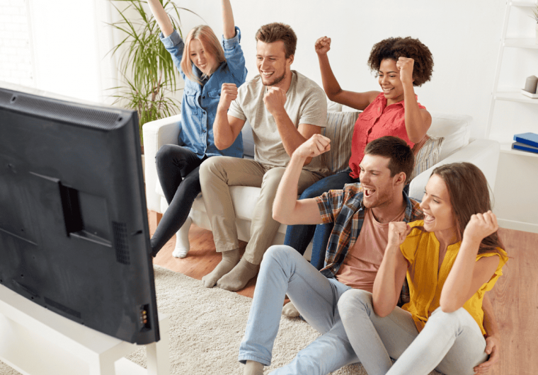 Young people enjoying DIRECTV Bulk Stream in modern apartment