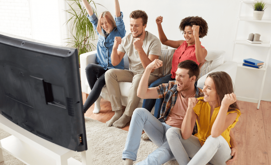 Young people enjoying DIRECTV Bulk Stream in modern apartment