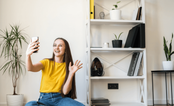 woman in apartment enjoying managed wi-fi while video chatting