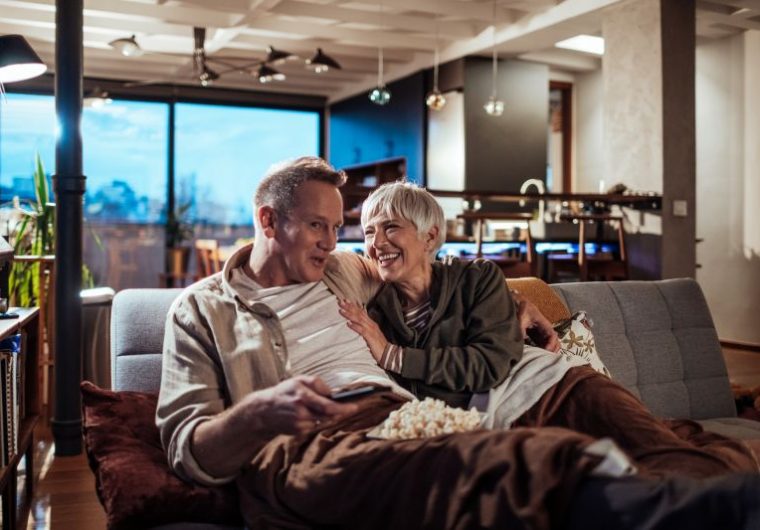 Couple at Senior Living Community Enjoying TV Features
