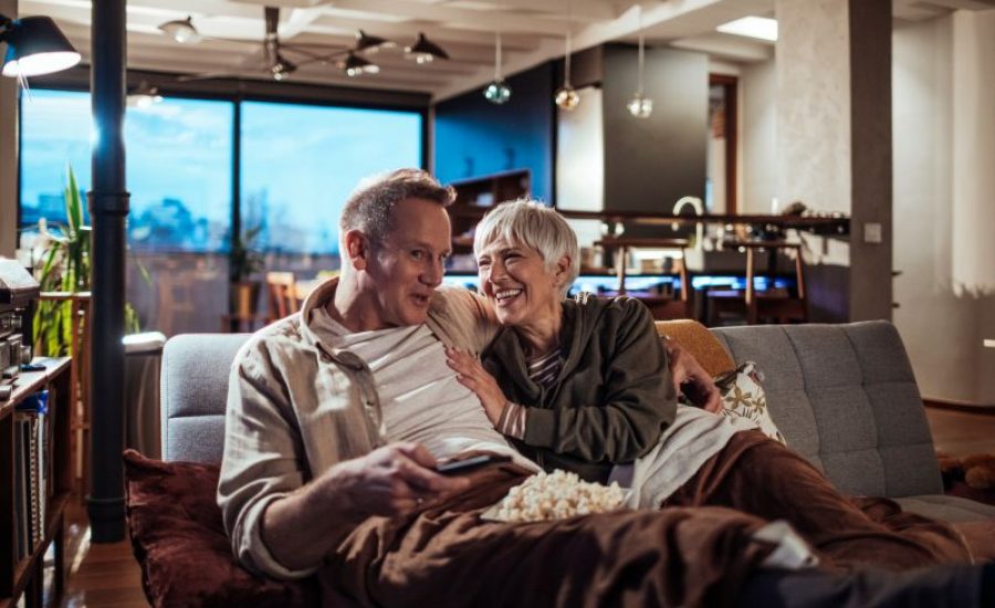 Couple at Senior Living Community Enjoying TV Features