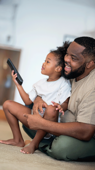 Father and Daughter Enjoying TV at their Multifamily Property