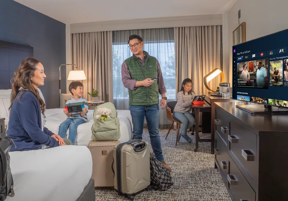 family enjoying TV in a hotel room