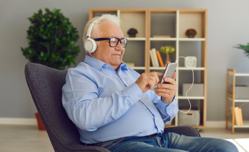 Elderly Gentleman Enjoying Technology