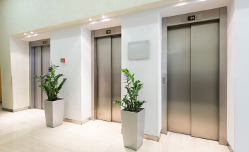 An empty hotel hallway and elevators