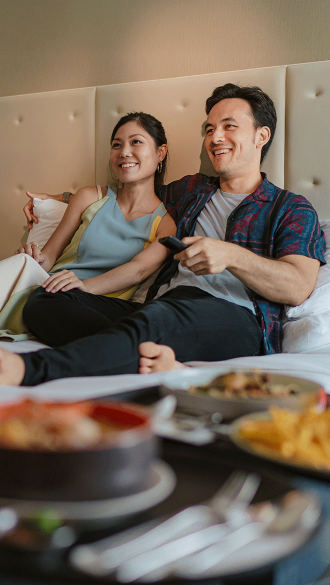 Couple Enjoying DIRECTV Service at Apartment
