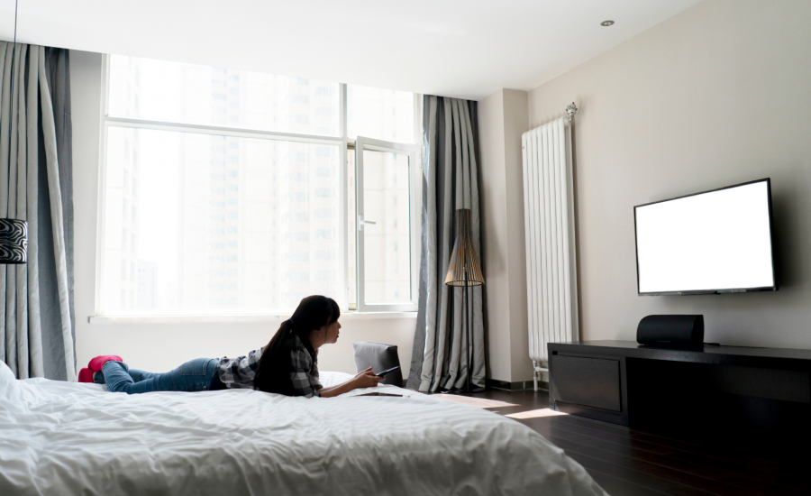 Woman Watching TV In Hotel
