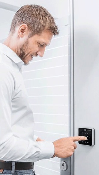 man-at-door-keypad