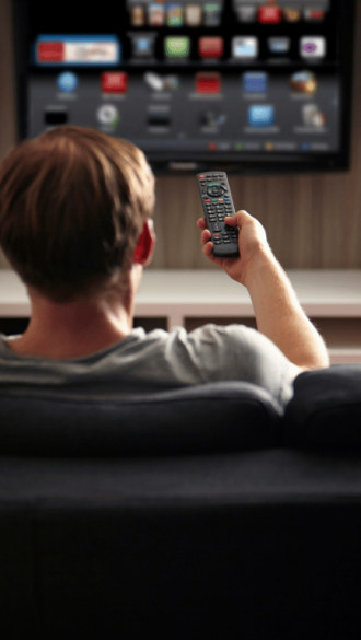 man watching tv in hotel