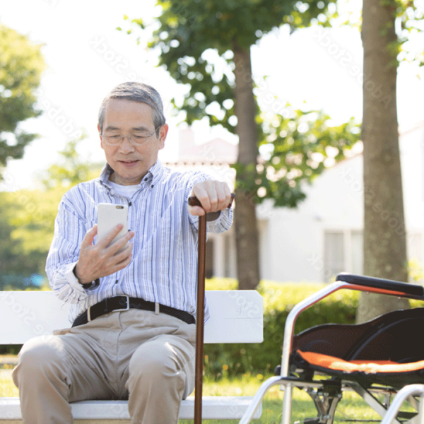 man-with-cane-phone-wheelchair