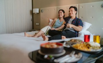 people enjoying in-room entertainment through directv and google